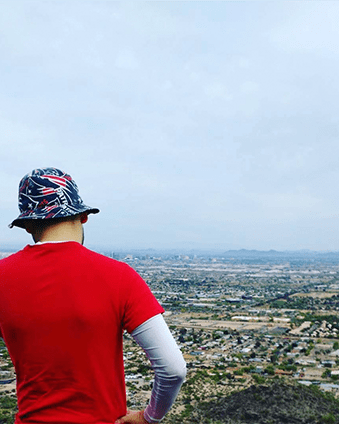 Juan Pablo on a hike, looking out at Phoenix, Arizona.