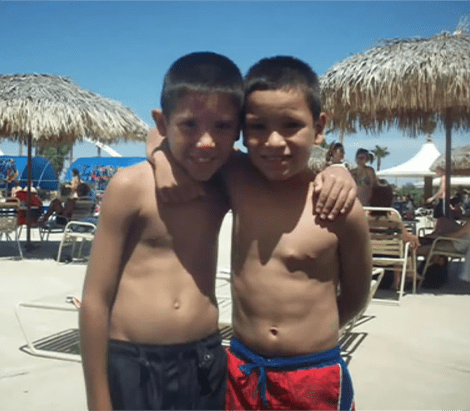 Young Juan Pablo at the beach with his brother.
