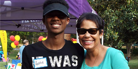 Young Austin posing and smiling with a woman